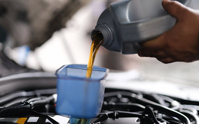 Porsche Mechanic Pouring Fresh Motor Oil